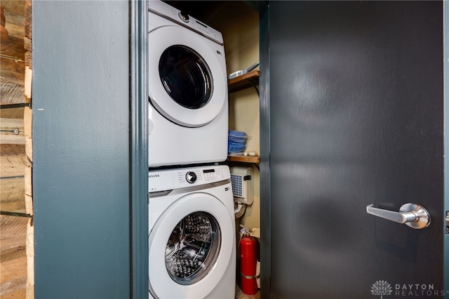 laundry area with stacked washer and dryer