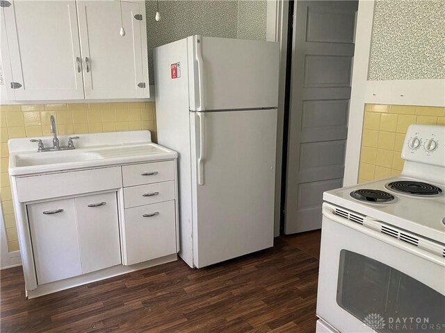 kitchen featuring white appliances, white cabinets, sink, and tasteful backsplash