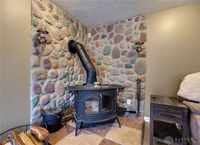 interior details with a textured ceiling and a wood stove