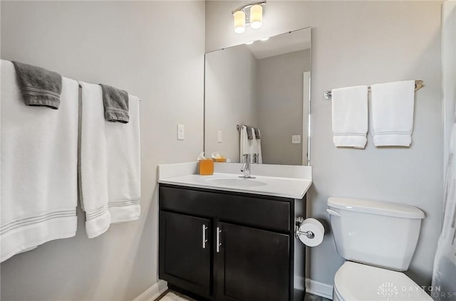 bathroom featuring toilet and vanity