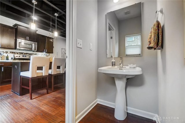 bathroom featuring hardwood / wood-style floors and tasteful backsplash