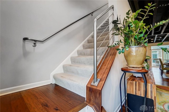 staircase featuring hardwood / wood-style flooring