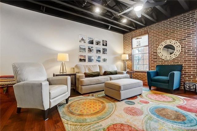 living room with ceiling fan, brick wall, and wood-type flooring