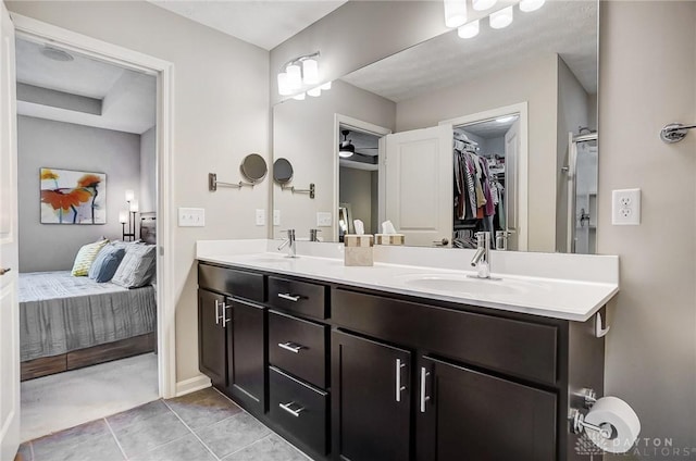 bathroom featuring vanity, tile patterned floors, and walk in shower