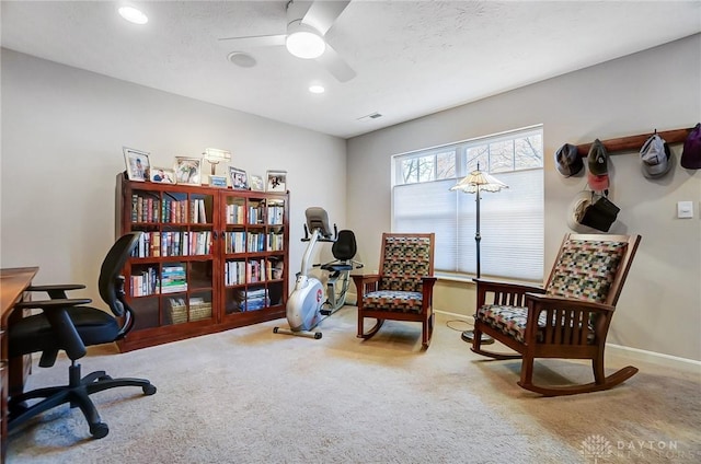 sitting room featuring ceiling fan and carpet floors