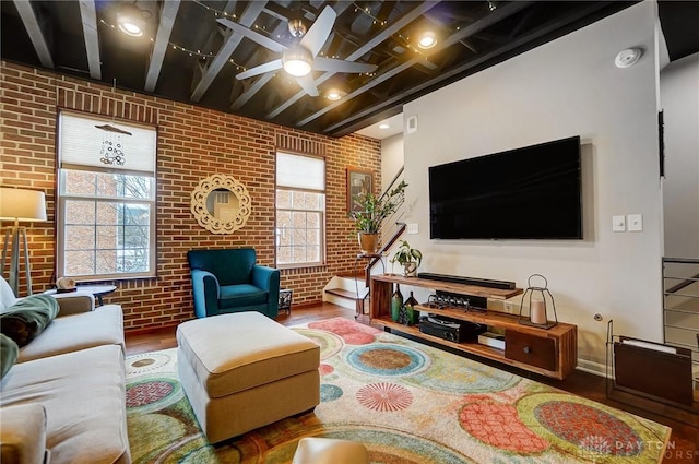 living room featuring brick wall, hardwood / wood-style floors, and ceiling fan