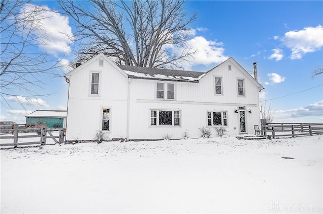 view of snow covered rear of property