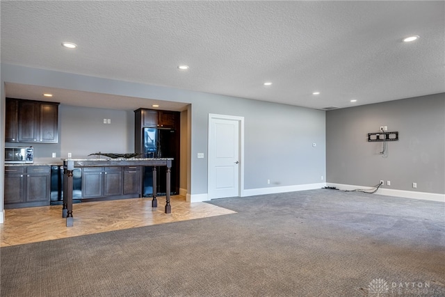 living room with a textured ceiling and light carpet