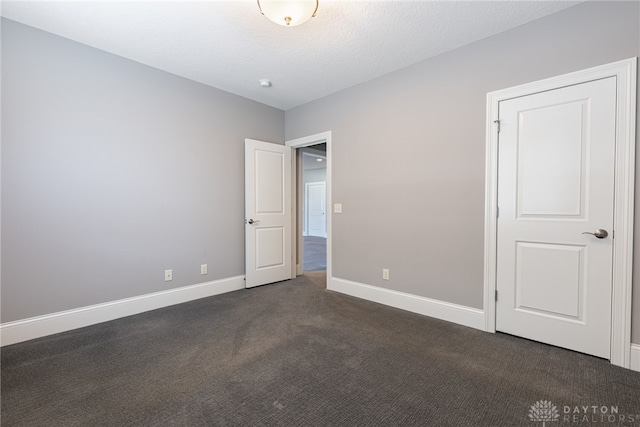 unfurnished bedroom featuring dark colored carpet