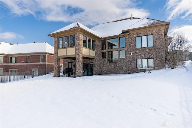 view of snow covered back of property