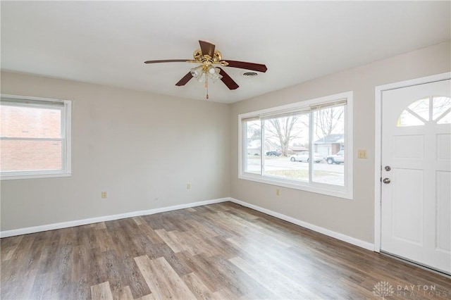 entrance foyer with ceiling fan and wood-type flooring