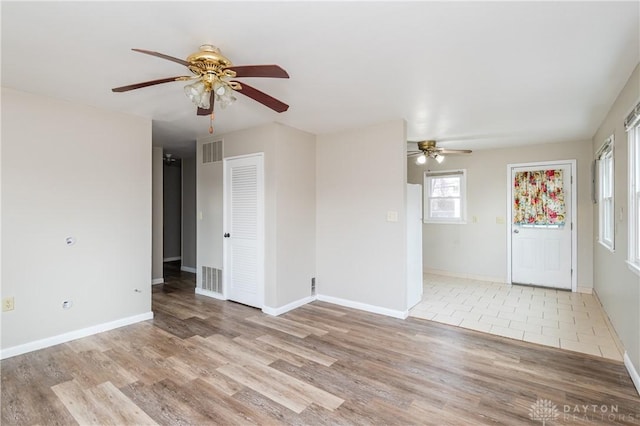 unfurnished room featuring light wood-type flooring and ceiling fan