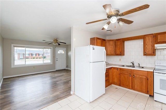 kitchen with sink, white appliances, ceiling fan, and backsplash