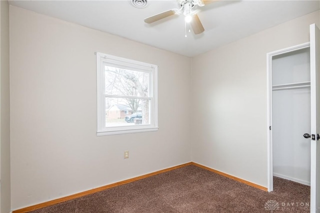 unfurnished bedroom featuring ceiling fan, a closet, and carpet floors