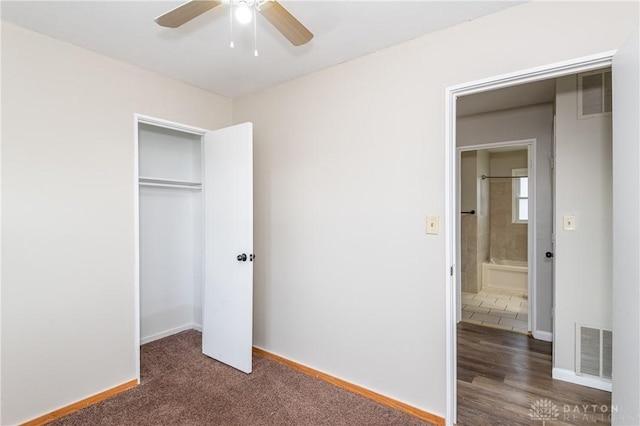 unfurnished bedroom featuring ceiling fan and a closet