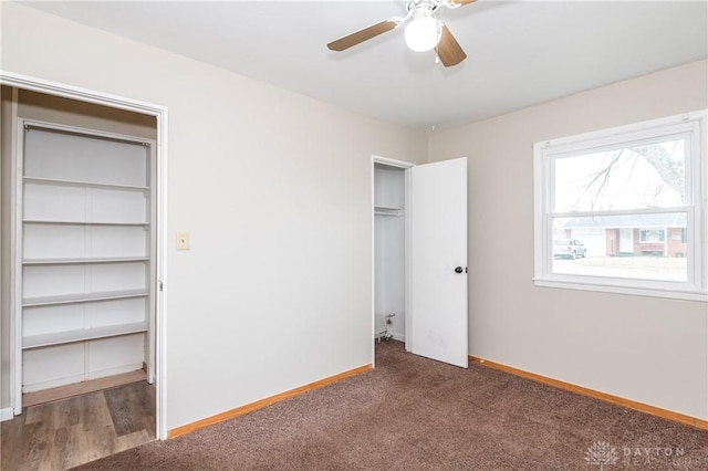 unfurnished bedroom featuring ceiling fan and dark colored carpet