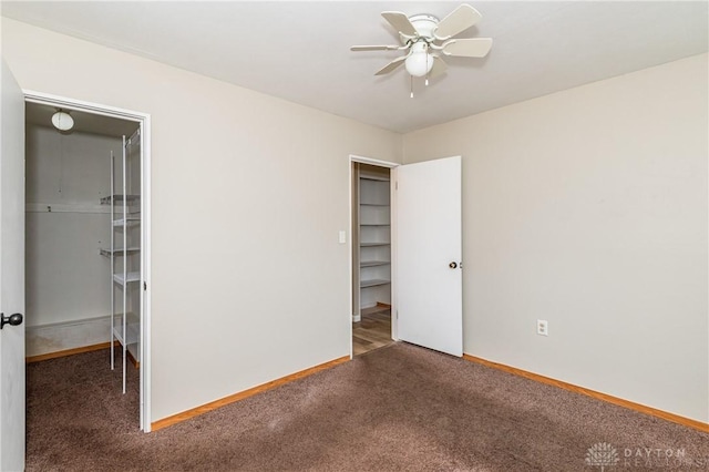 unfurnished bedroom featuring a closet, ceiling fan, and dark colored carpet