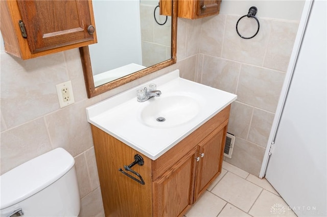 bathroom featuring tile walls, tile patterned flooring, vanity, and toilet