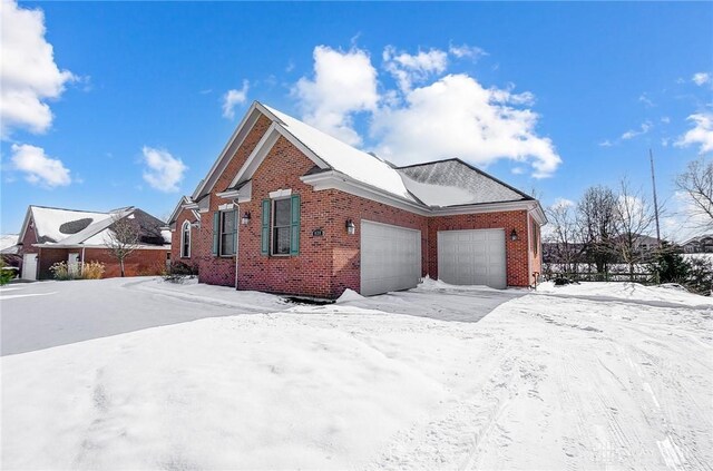 view of snowy exterior with a garage