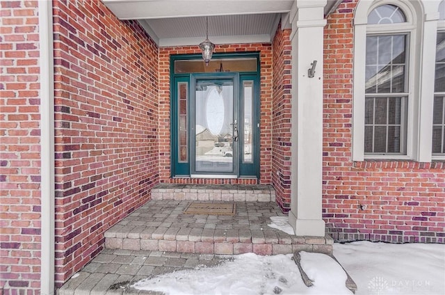 view of snow covered property entrance