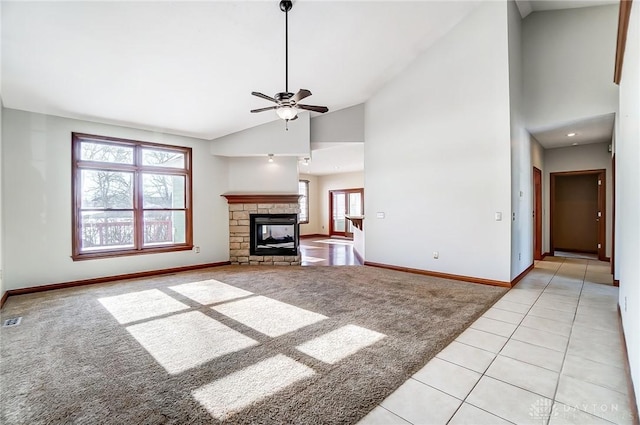 unfurnished living room with light colored carpet, a fireplace, high vaulted ceiling, and a wealth of natural light