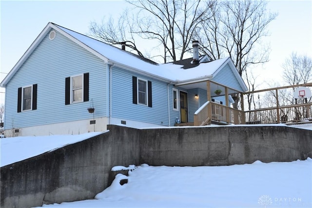 snow covered property featuring covered porch