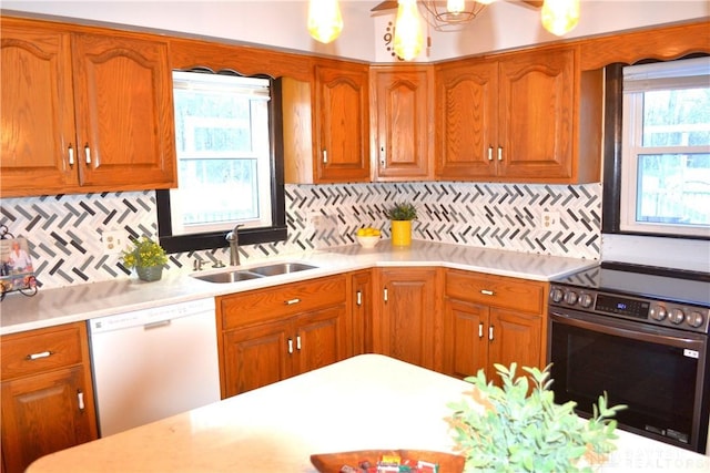 4403 Clayton Rd, Perry Twp, OH 45309 - kitchen featuring stainless steel range with electric stovetop, white dishwasher, a sink, and light countertops