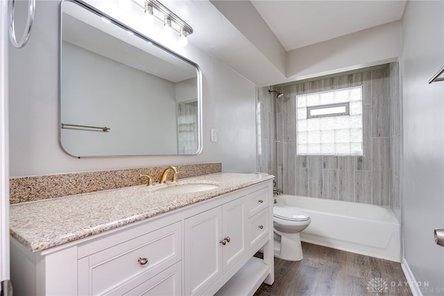 full bath with toilet, vanity,  shower combination, and wood finished floors