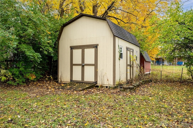 view of shed featuring fence