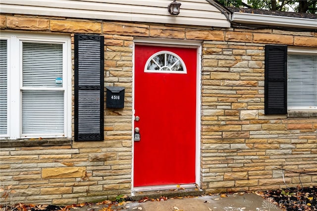 doorway to property with stone siding