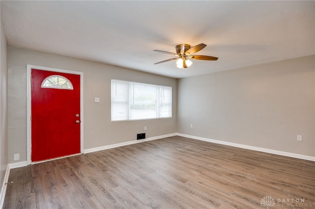 entryway featuring wood finished floors, a ceiling fan, and baseboards