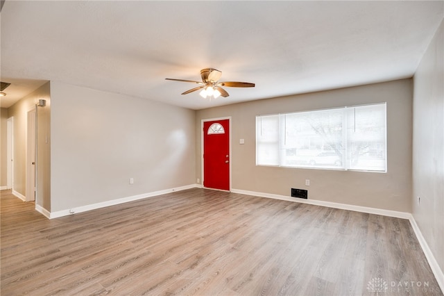 entryway featuring visible vents, baseboards, wood finished floors, and a ceiling fan