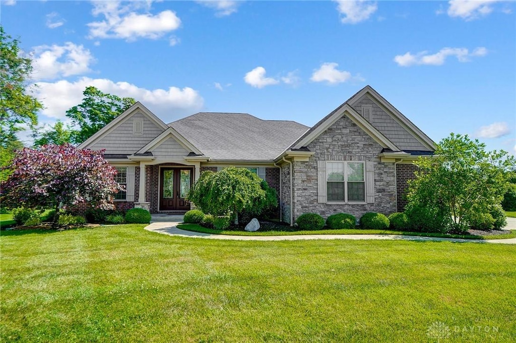 craftsman-style home with a front yard