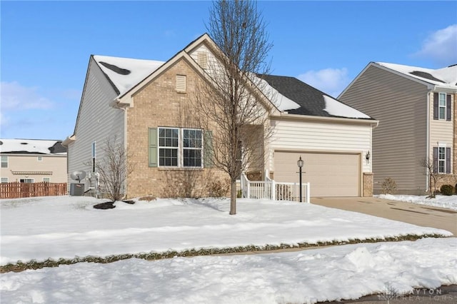 view of front of house featuring a garage and central AC unit