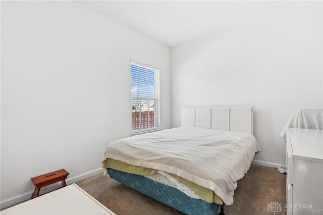 bedroom with dark colored carpet