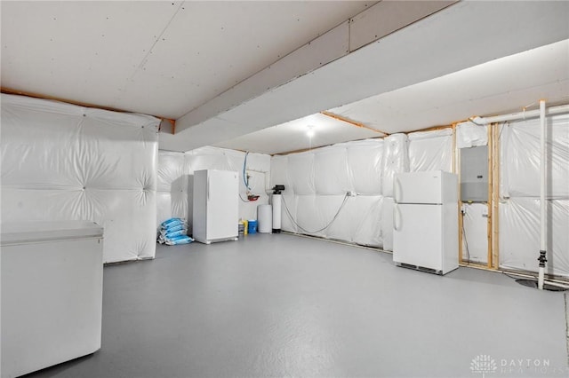 basement featuring white fridge and electric panel