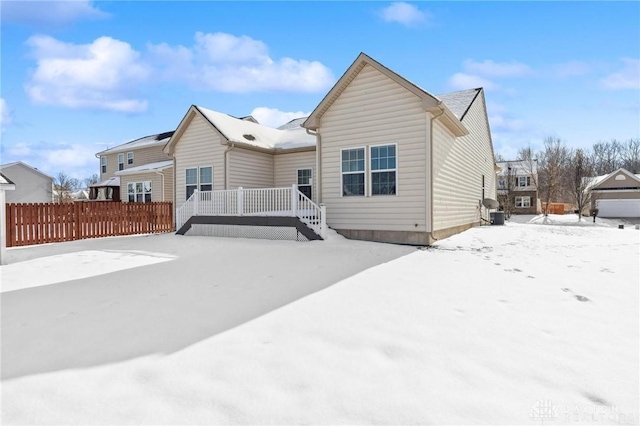 view of snow covered back of property