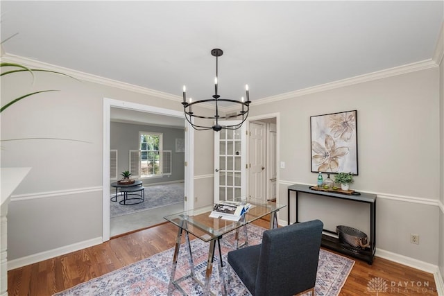 dining space with a notable chandelier, ornamental molding, and hardwood / wood-style floors