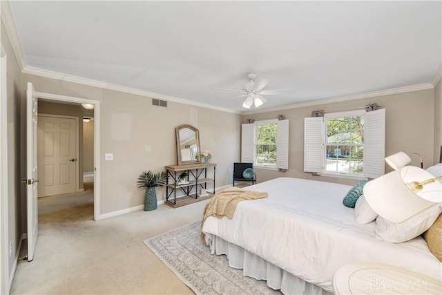 carpeted bedroom featuring ceiling fan and crown molding