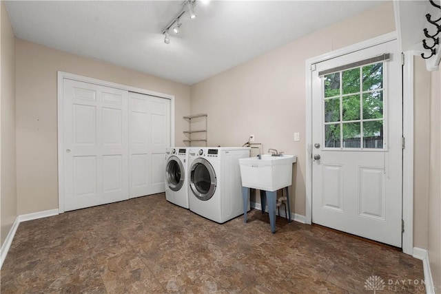 washroom featuring washer and dryer and rail lighting