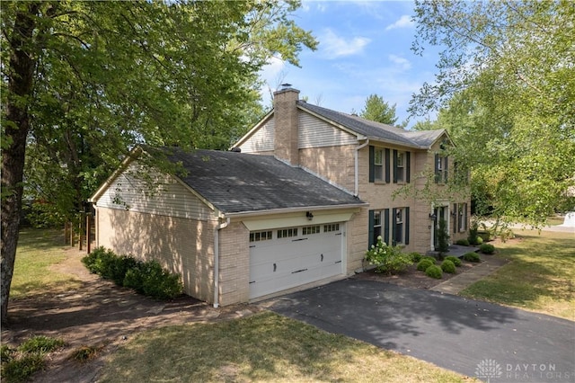 view of home's exterior featuring a garage and a yard