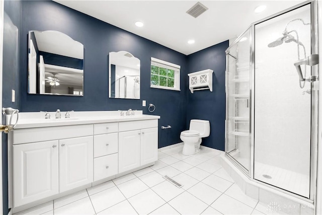 bathroom featuring toilet, tile patterned flooring, ceiling fan, a shower with shower door, and vanity