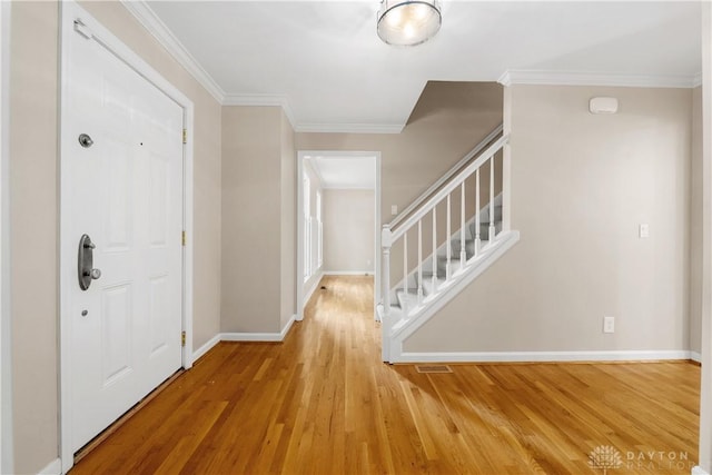 foyer featuring crown molding and wood-type flooring