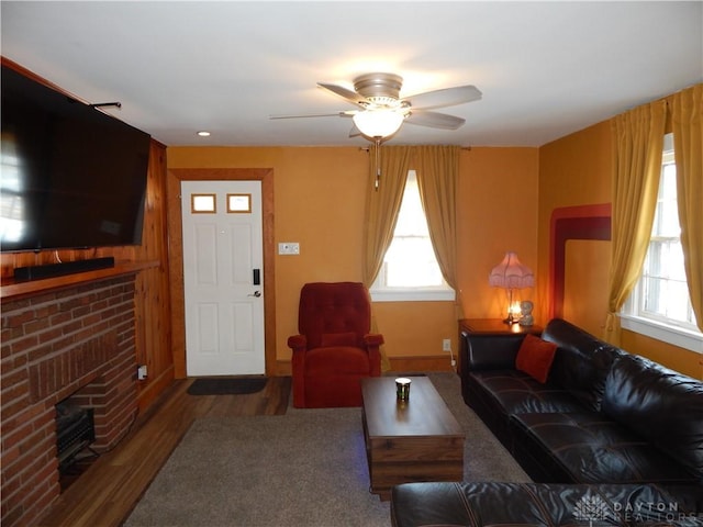 living room with a fireplace and ceiling fan