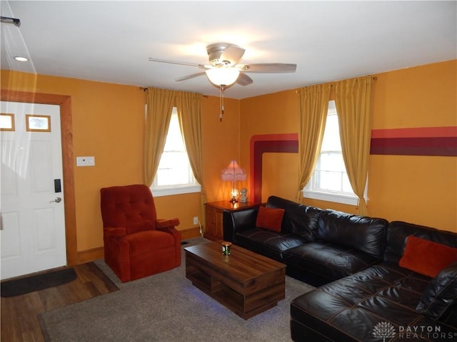 living room featuring ceiling fan and hardwood / wood-style floors