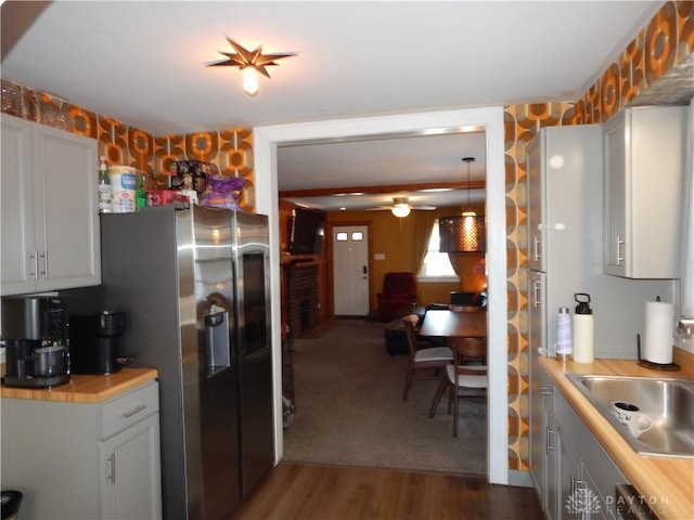 kitchen featuring butcher block counters, sink, white cabinetry, stainless steel fridge with ice dispenser, and dark hardwood / wood-style flooring