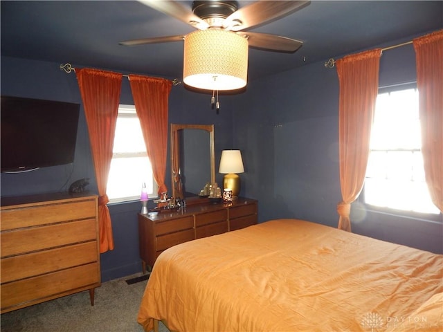 bedroom with carpet floors, ceiling fan, and multiple windows