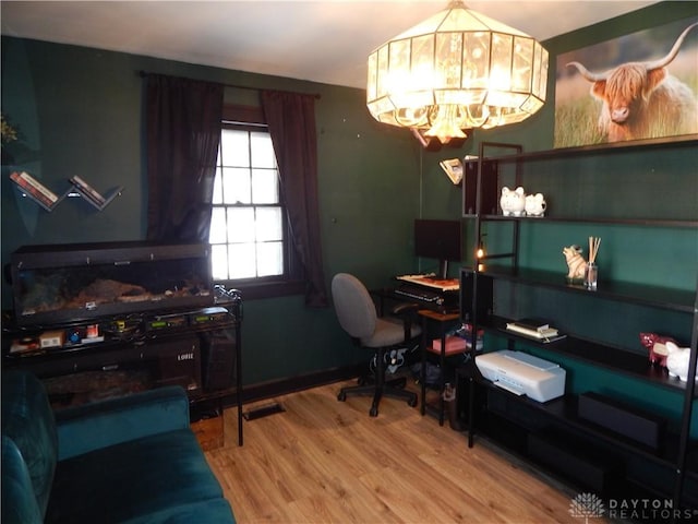 office with an inviting chandelier and wood-type flooring