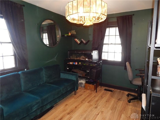 office space with a notable chandelier and wood-type flooring