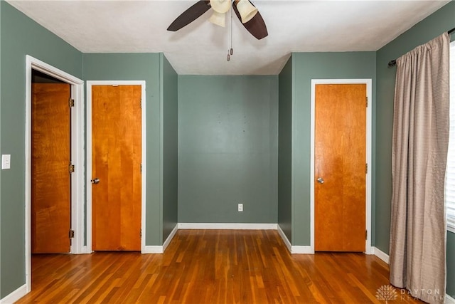 unfurnished bedroom featuring ceiling fan and wood-type flooring